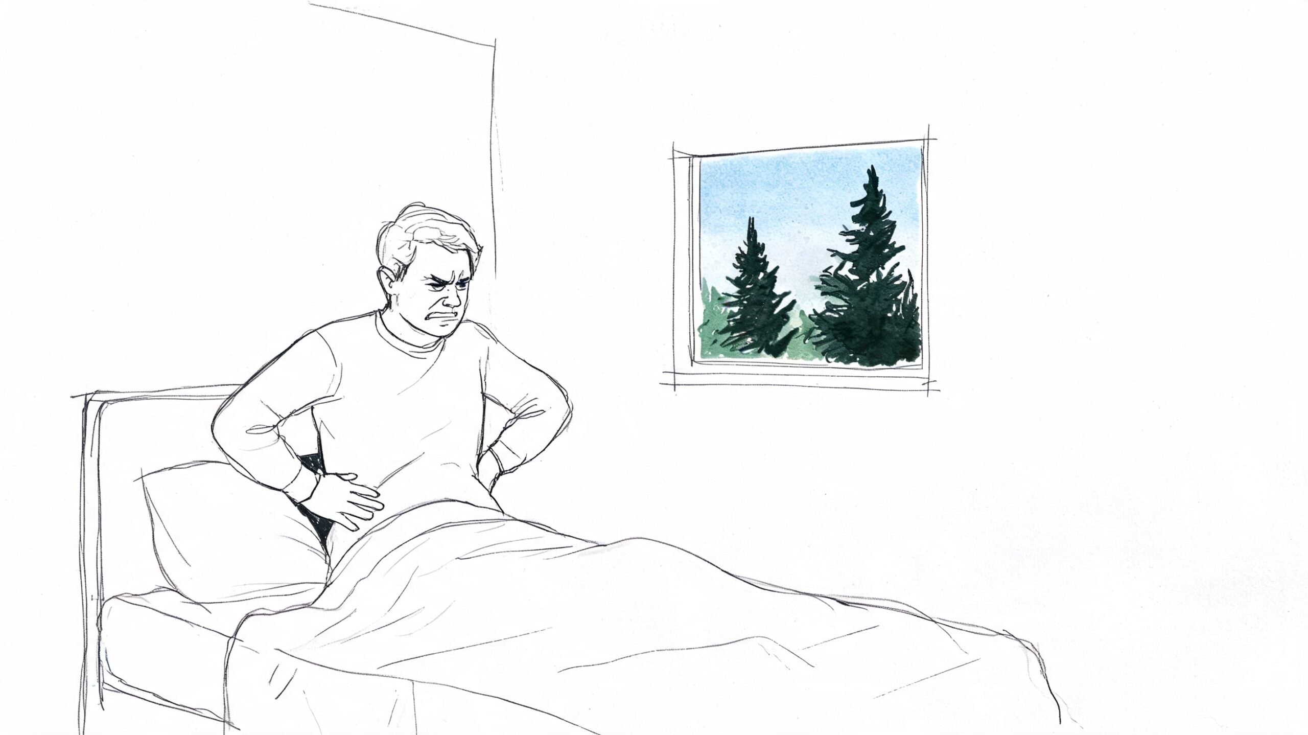 A person sitting up in bed with a frustrated expression while holding their painful lower back.